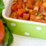 Bruschetta made with fresh garden tomatoes, basil, onion, garlic and cheese in a balsamic vinaigrette makes a delicious appetizer or afternoon snack.