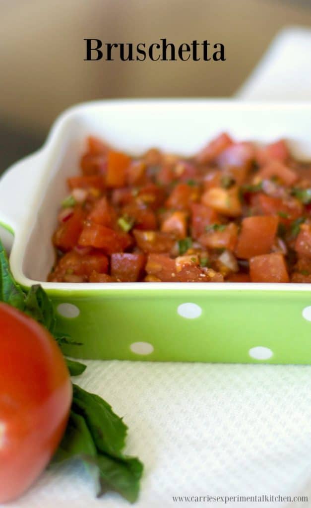 A close up of bruschetta in a green and white dish.