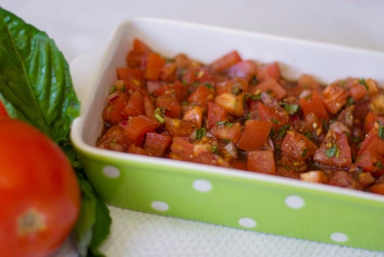 Tomato Bruschetta in a green dish.