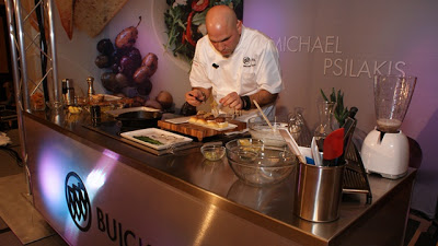 A man cooking in a kitchen preparing food, with Wine and Chef