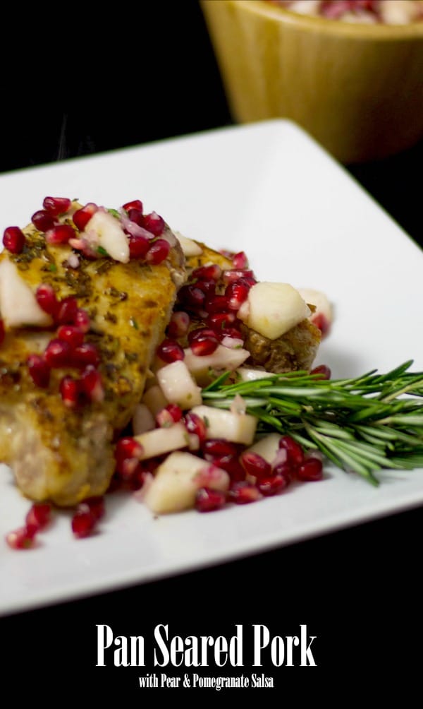 A plate of food on a table, with Pork and Pomegranate salsa