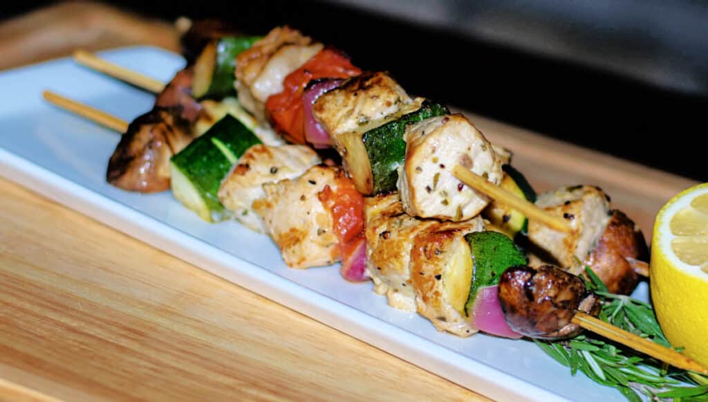 Rosemary Grilled Pork Skewers on a plate with vegetables
