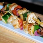 Rosemary Grilled Pork Skewers on a plate with vegetables