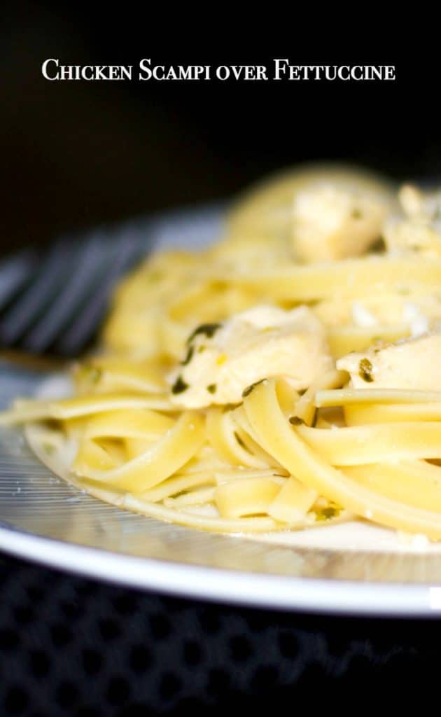 Chicken Scampi over Fettuccine on a plate with a fork 