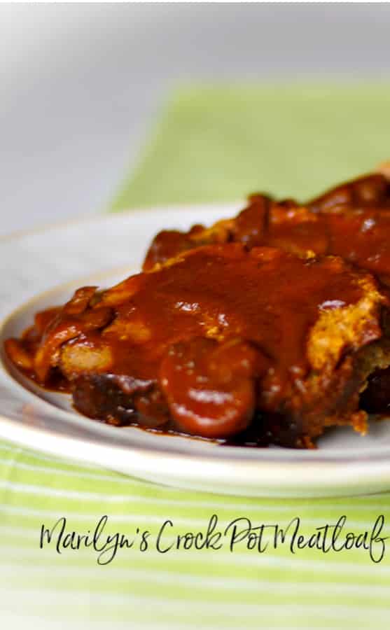 Sliced meatloaf on a plate with a mushroom gravy. 
