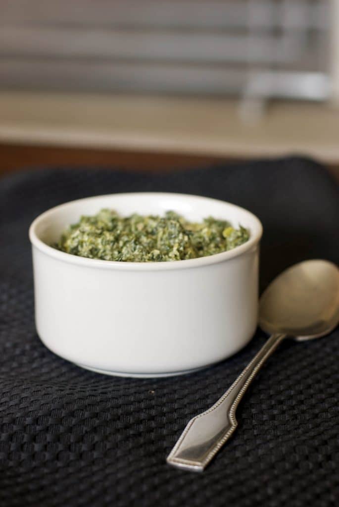 A cup of Herb Creamed Spinach on a table