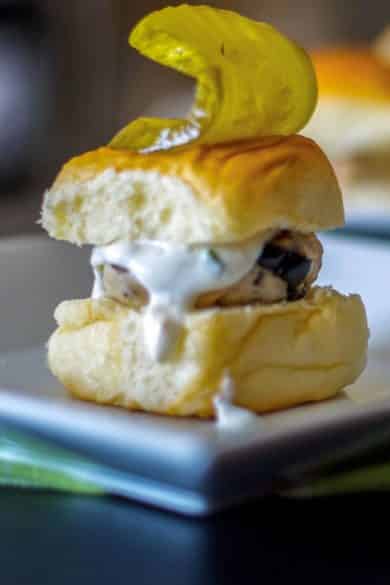 Mediterranean Turkey Sliders made with lean ground turkey, Kalamata olives, Feta cheese, and oregano on top of a sweet slider bun.