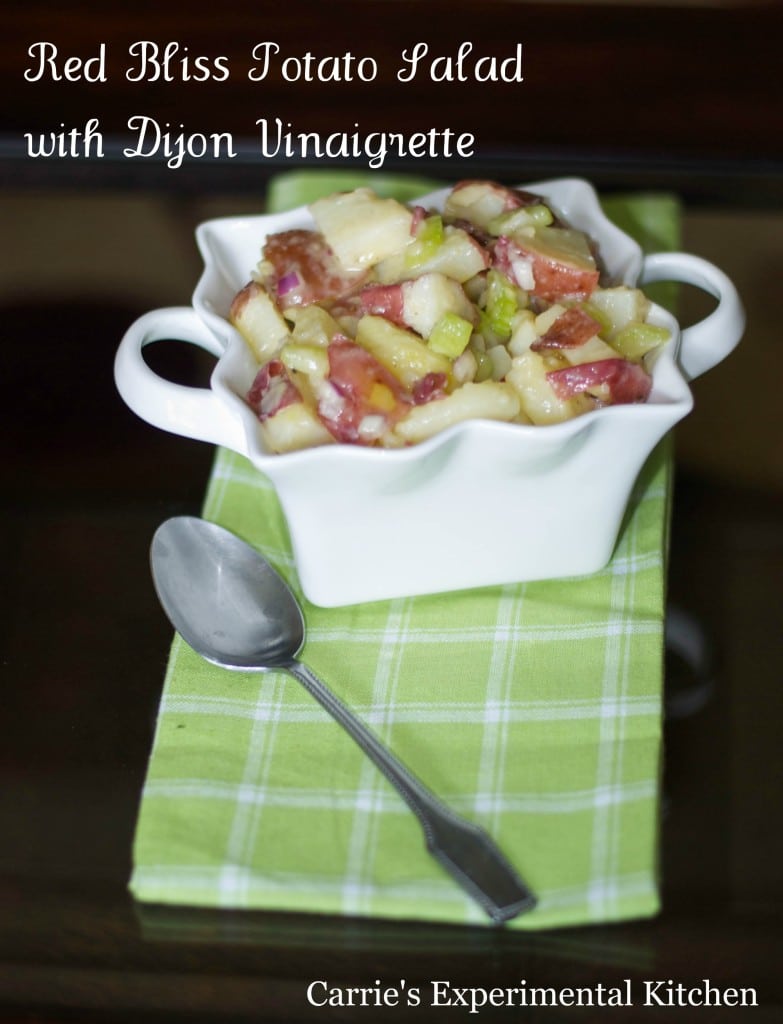 red bliss potato salad in a white square dish with a spoon