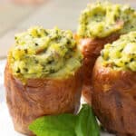 Stuffed baked potatoes made with fresh basil pesto and spices; then baked until super creamy and delicious makes a super flavorful side dish.