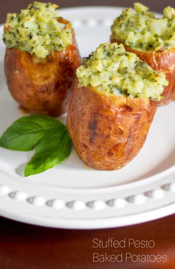 Stuffed baked potatoes made with fresh basil pesto and spices; then baked until super creamy and delicious makes a super flavorful side dish. 