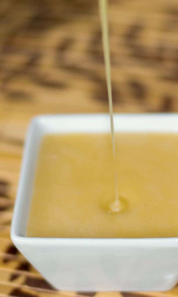 Oriental Dressing being poured in a white small dish