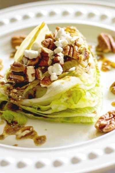  Grilled Iceberg lettuce wedge salad topped with whole pecans and crumbled Goat cheese; then drizzled with a balsamic vinaigrette. 