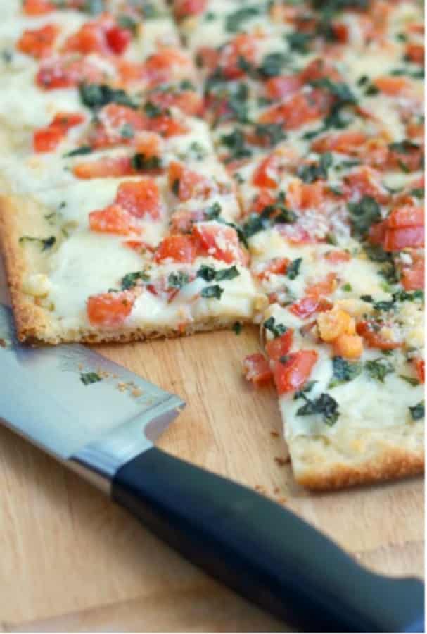 Caprese Flatbread made with tomatoes, fresh basil and Mozzarella is perfect when served as an appetizer, for lunch or dinner.  