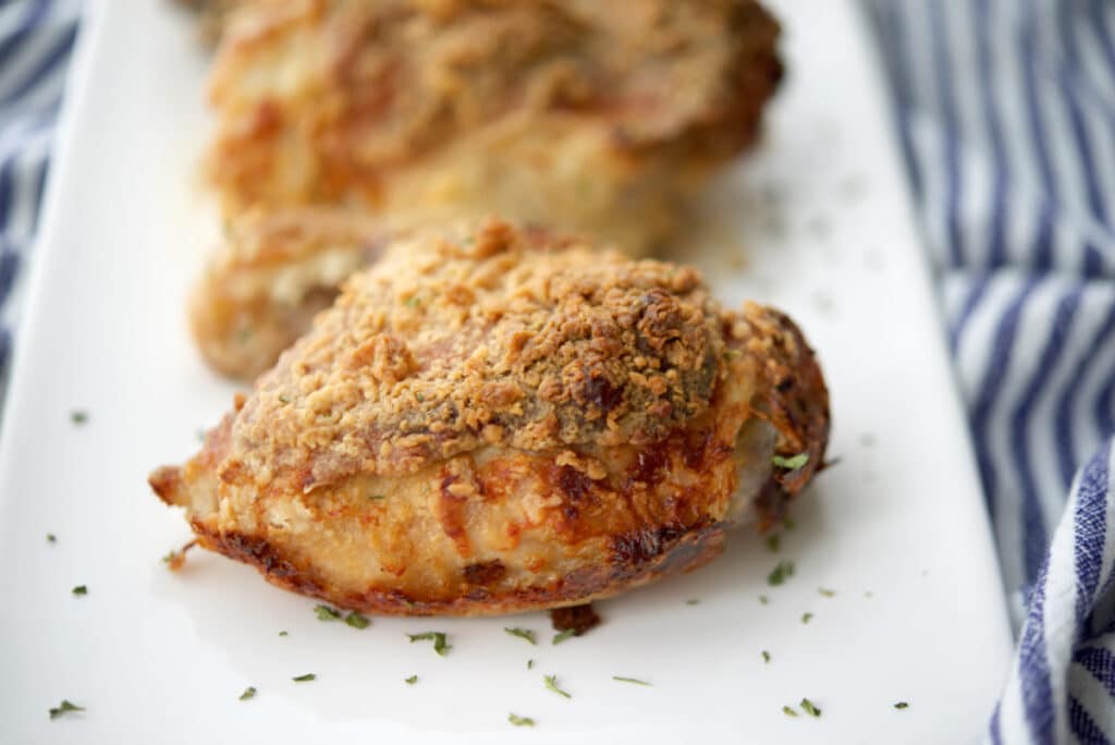 a close up of chicken thighs on a white plate