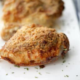 a close up of chicken thighs on a white plate