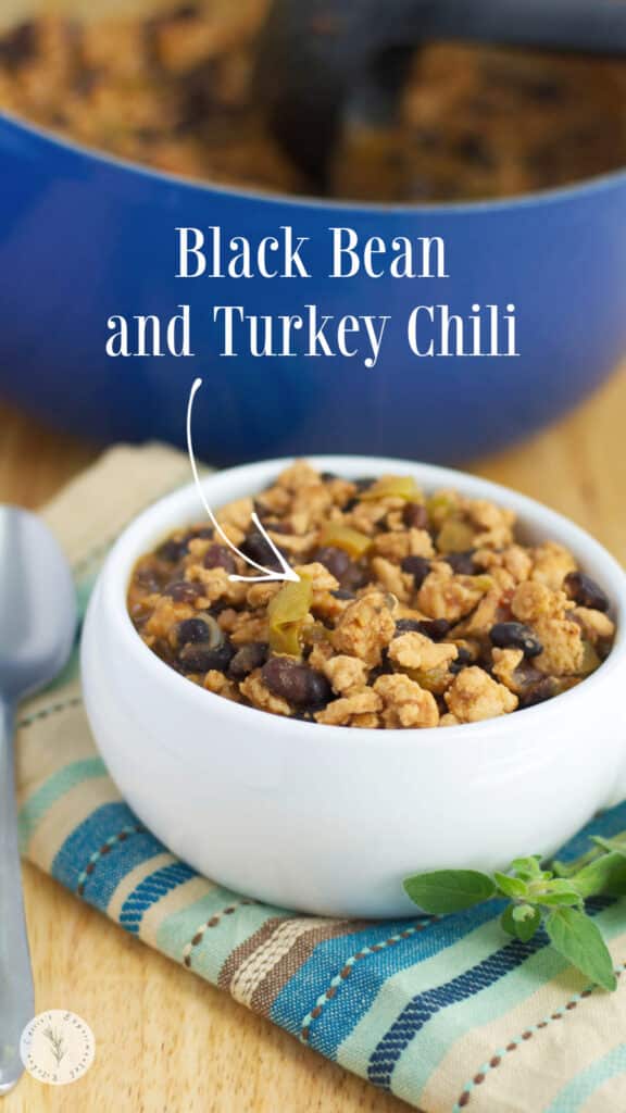 Black Bean and Turkey Chili in a white soup crock and a blue Dutch oven