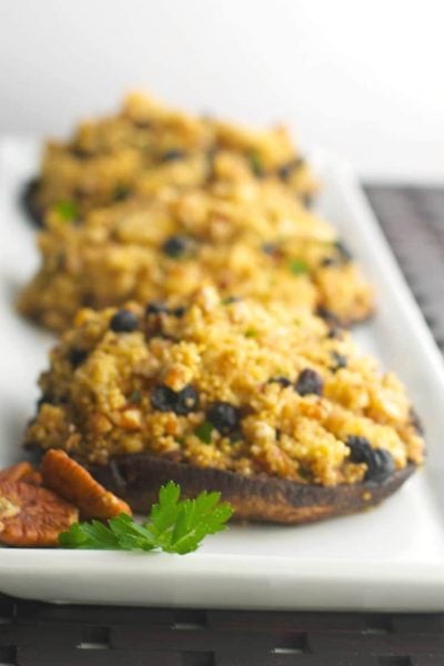 Portobello mushrooms stuffed with blueberries, pecans, crumbled goat cheese and quinoa is a healthy weeknight meal idea that's loaded with flavor.