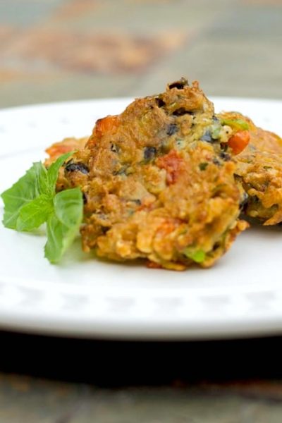 Learn how to make this tasty Greek style side dish for Eggplant Fritters with grated eggplant, garlic, basil, tomatoes and scallions.