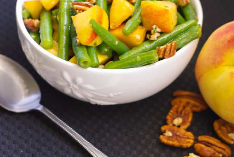 Fresh green beans and sliced peaches tossed with chopped pecans in a maple vinagrette is a delightfully flavorful Autumnal salad.