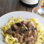 Beef Stroganoff made with beef cubes slowly simmered in a slow cooker with mushrooms, garlic, fresh herbs in a thick, red wine brown gravy.