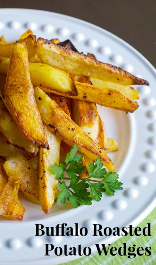 Buffalo Roasted Potato Wedges made with russet potatoes and tossed with melted butter and hot sauce; then roasted until golden brown.