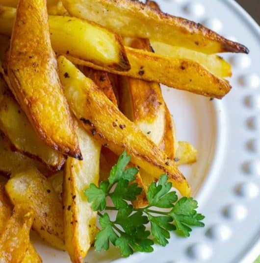 Buffalo Roasted Potato Wedges made with russet potatoes and tossed with melted butter and hot sauce; then roasted until golden brown. 