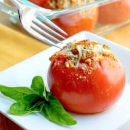 a close up of shrimp stuffed tomato on a plate