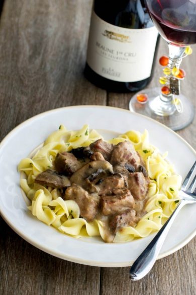 Beef Stroganoff on a plate over egg noodles.