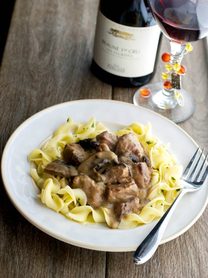 Beef Stroganoff on a plate over egg noodles. 