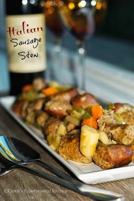 A plate of food on a table, with Sausage and Stew