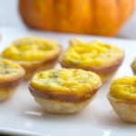 Use a mini muffin tin to create these Pumpkin and Brie Mini Quiche to serve as individual appetizers for your next holiday gathering.