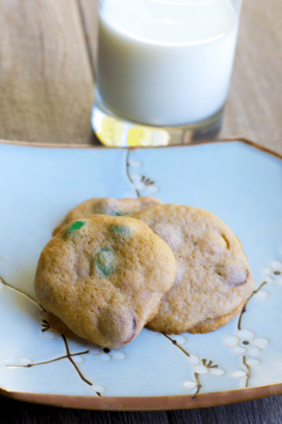 Soft and chewy Pumpkin Spice M&M Cookies go perfectly with a tall glass of milk for an afternoon snack or special Fall treat.