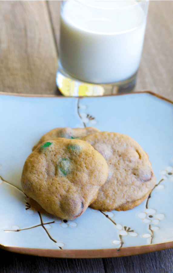 Soft and chewy Pumpkin Spice M&M Cookies go perfectly with a tall glass of milk for an afternoon snack or special Fall treat.