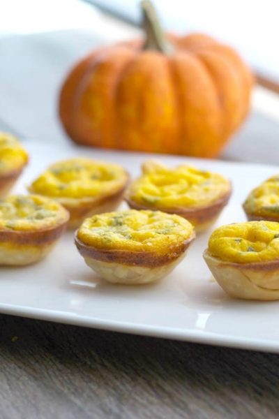 Pumpkin and Brie Mini Quiche on a white plate.