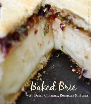 A close up of Baked Brie with Rosemary, Cherries and Honey