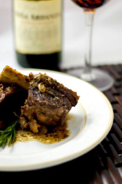 Beef short ribs slowly cooked in red wine, garlic, rosemary and two types of mustard are so tender and delicious.