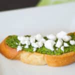 Pesto and Goat Cheese Crostini made with fresh basil pesto and crumbled Goat cheese is a deliciously flavorful appetizer.