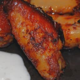 Chicken wings tossed with tabasco sauce and honey; then baked until crispy make a tasty appetizer or game day snack. 