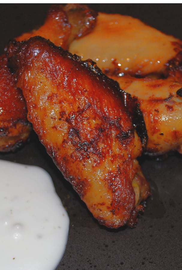 Chicken wings tossed with tabasco sauce and honey; then baked until crispy make a tasty appetizer or game day snack. 