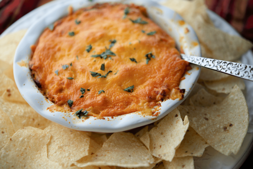 a close up of buffalo chicken dip in a dish