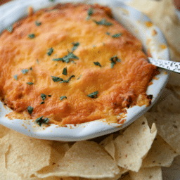 a close up of buffalo chicken dip in a dish