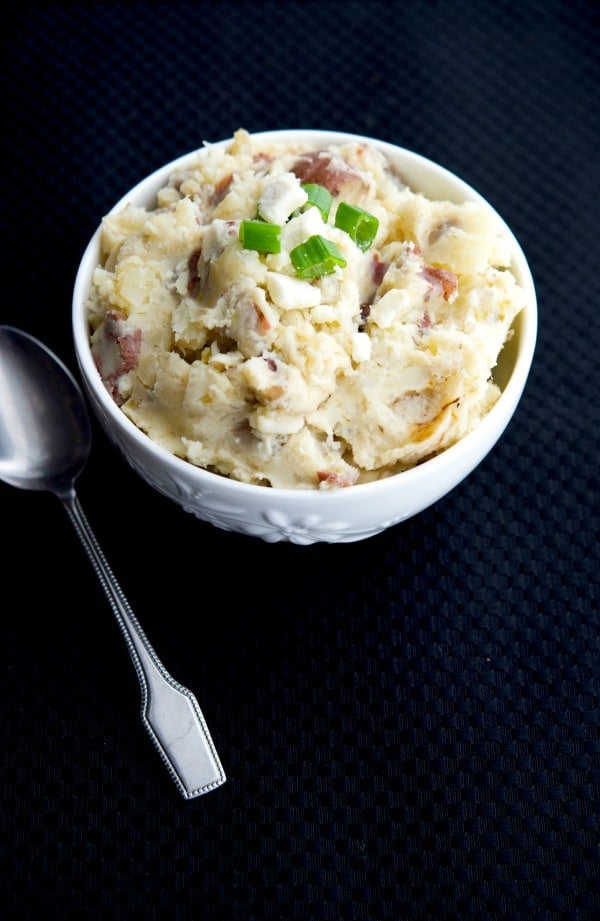 Greek Mashed Potatoes made in the crockpot with red bliss potatoes, scallions, oregano, lemon and Feta cheese make a tasty, easy side dish.