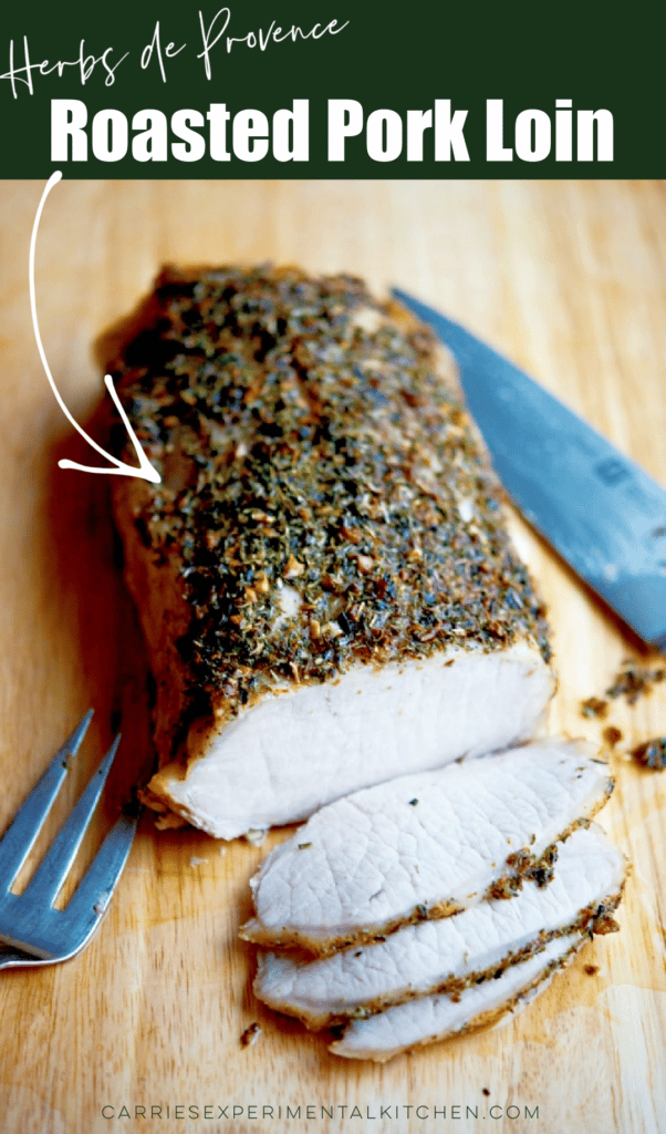 A close up of roasted pork loin on a wooden cutting board