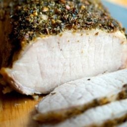 Herbs de Provence Encrusted Pork Loin with a slice cut.