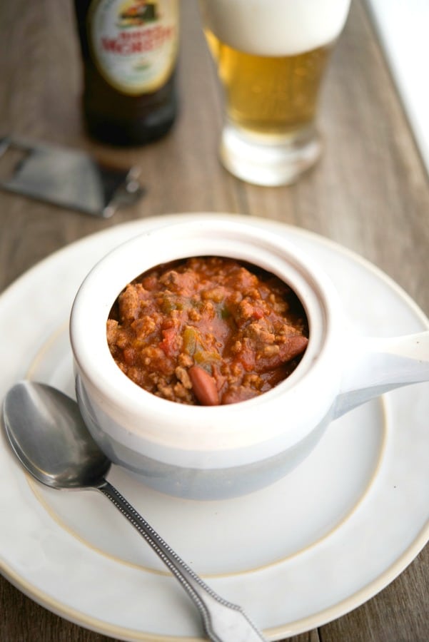 Beef chili with beer and vegetables in a soup crock.