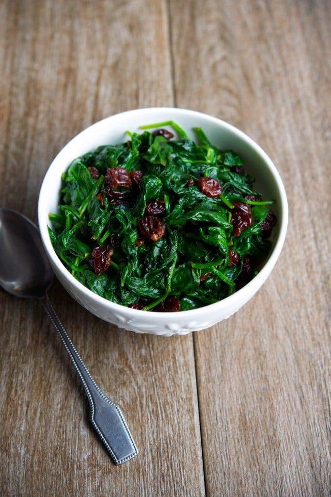 Fresh baby spinach sauteed with dried cherries is a tasty vegetable side dish that's ready in under ten minutes. 