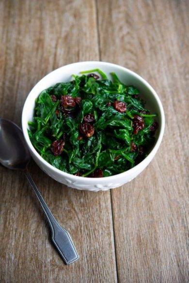 Fresh baby spinach sauteed with dried cherries is a tasty vegetable side dish that's ready in under ten minutes. 