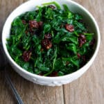 Fresh baby spinach sauteed with dried cherries is a tasty vegetable side dish that's ready in under ten minutes. Perfect for busy weeknights!