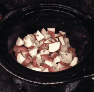Cut up potatoes in a crock pot. 