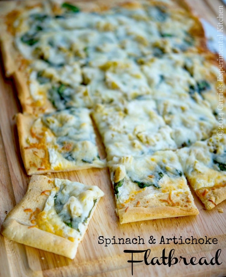 Spinach and Artichoke Flatbread pizza cut into squares.